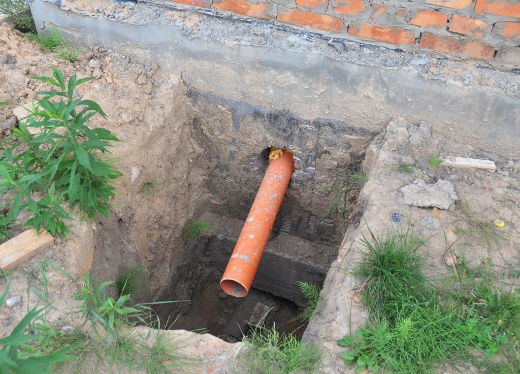 Build over sewer pipe. Foundation over sewer pipe drainage system.